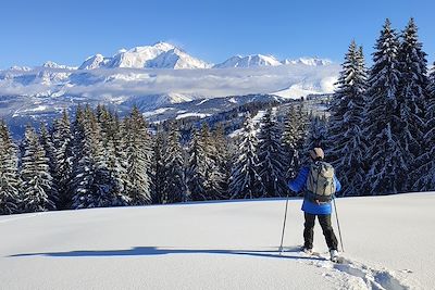 Randonneur en raquettes face au Mont-Blanc - France