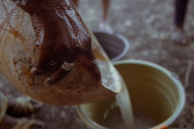 Geste de verser de l’eau au sein d’un groupe au Sénégal